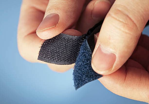 hands opening a Velcro 
